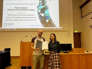 Thorsten receives his poster prize certificate from Executive Editor Michaela