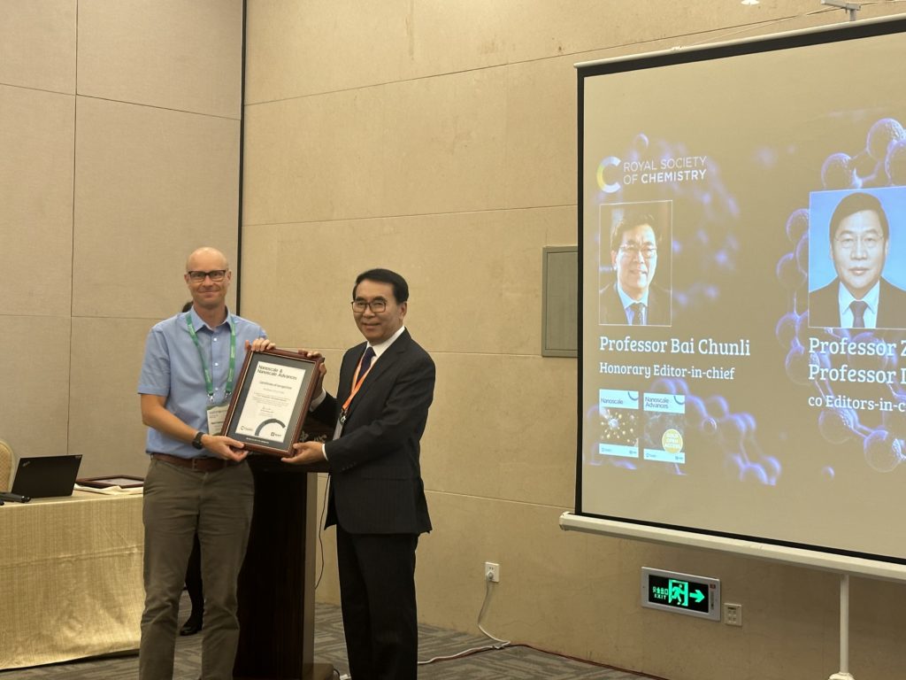 Publisher Dr Neil Hammond presents Prof Chunli Bai with a certificate of recognition from the journals Nanoscale and Nanoscale advances.